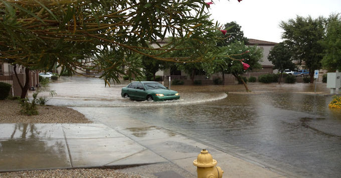Car driving through flooded street
